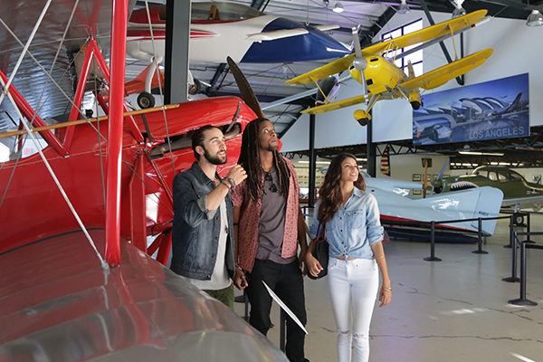 Three people exploring the Santa Monica Museum of Flying