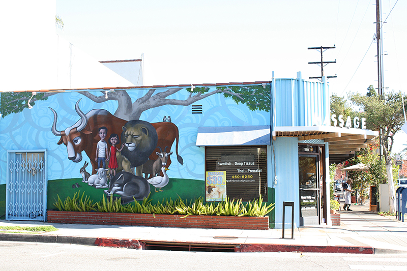 Mural of humans standing with animals