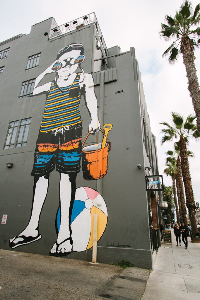 Mural of boy at beach with binoculars