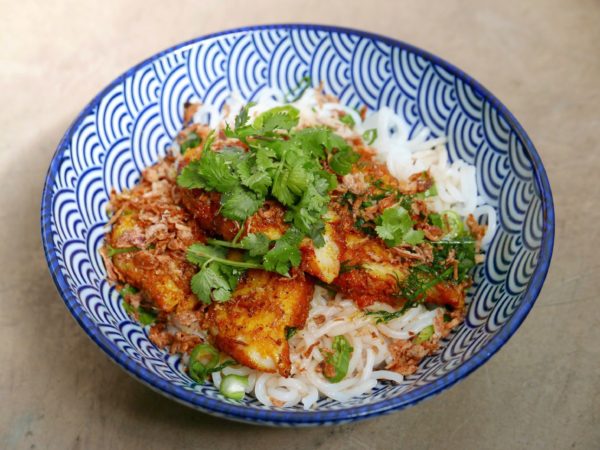 Turmeric fish noodles and whitefish tossed with dill, turmeric, crispy shallots and cilantro over thick rice noodles from Viet Noodle Bar