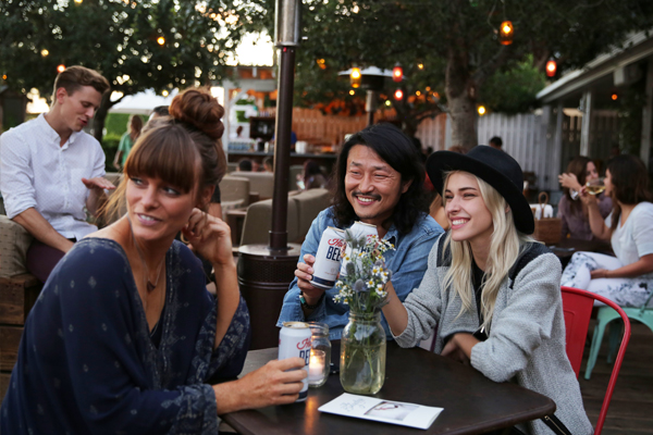 Group of friends drinking beer at The Bungalow in Santa Monica