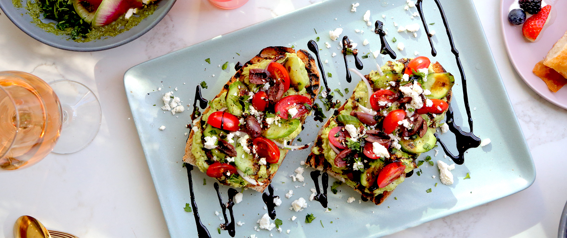Aerial photo of avocado toast, a salad, and a drink from Cult in Santa Monica.