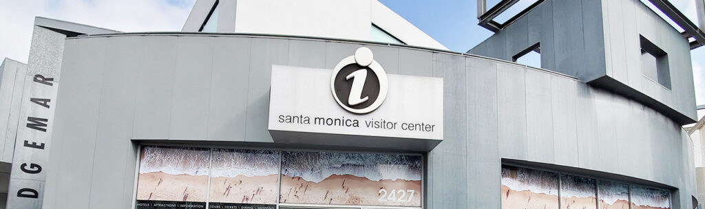 Image of visitors center building; grey building with info sign above