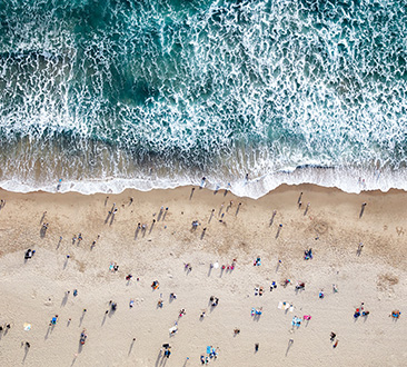 Beach and ocean waves; people on beach; aerial shot
