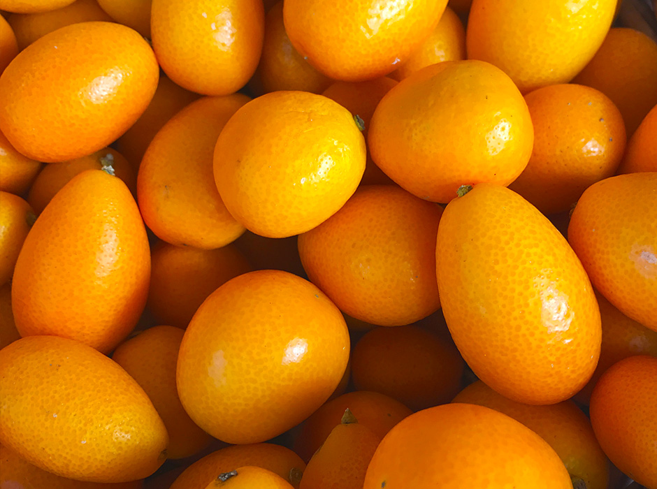 Pile of orange kumquats from above