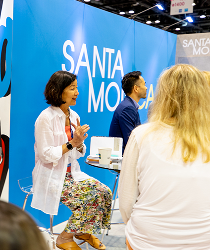 Women speaking at the Santa Monica Booth at IPW 2022.