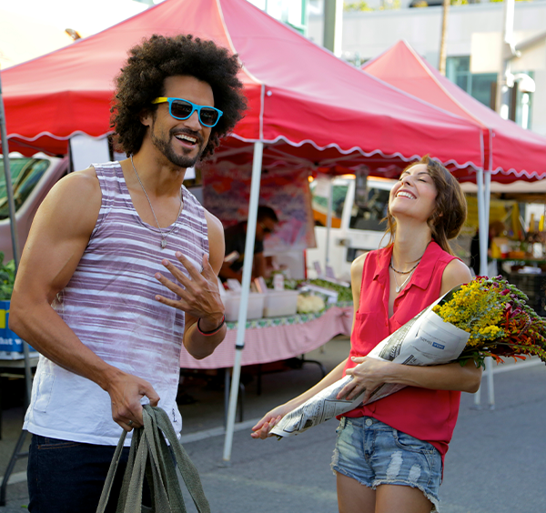 Man and woman laughing at the Santa Monica Farmers Market.