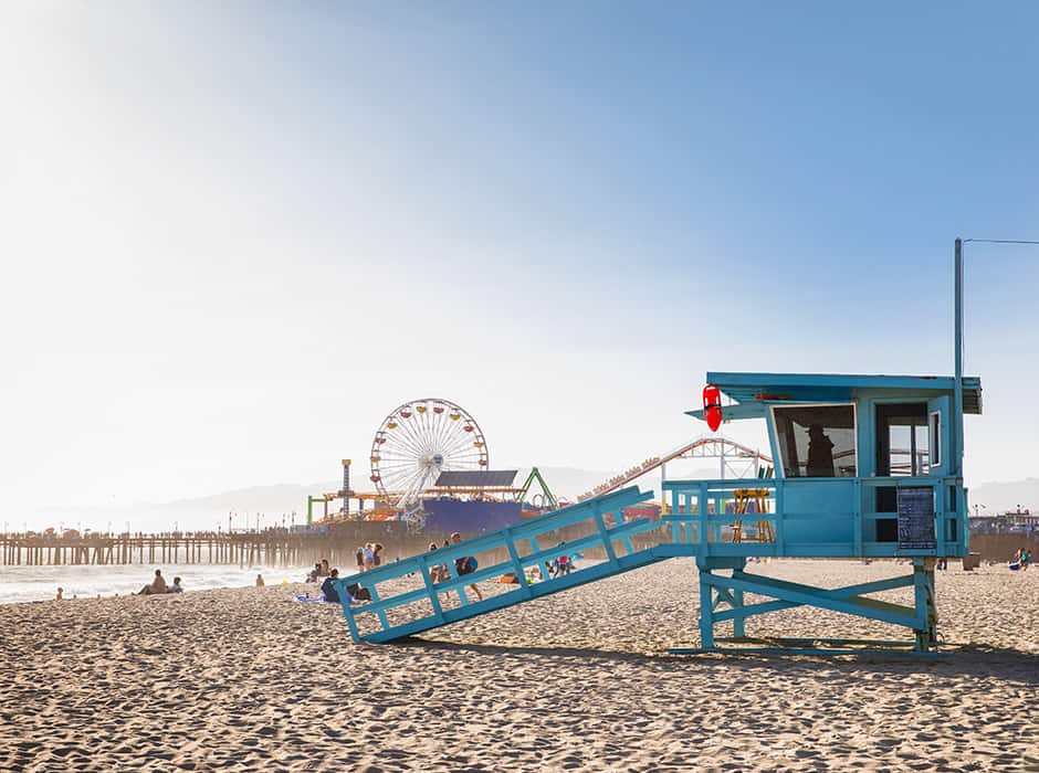 Blue sky; Santa Monica Pier and Pacific Park in background; Santa Monica Beach; Santa Monica lifeguard tower