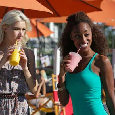 two friends drinking smoothies
